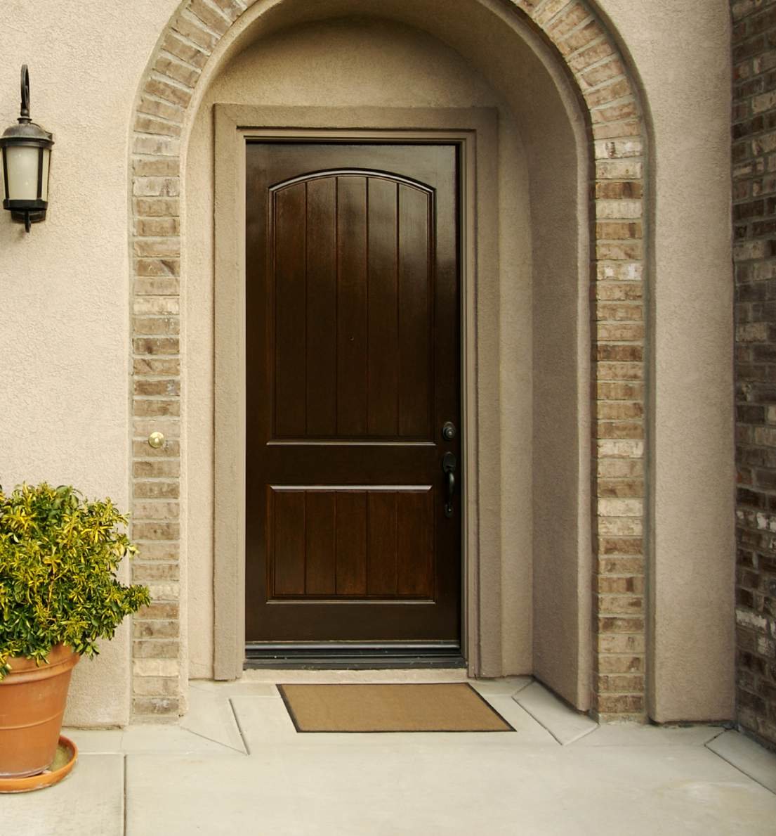 Arched wood entry door on a home